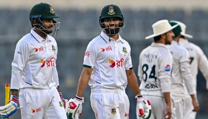 Bangladeshs Mahmudul Hasan Joy (left) and teammate Shadman Islam walk back to the pavilion at the end of the third days play of the first Test match against Pakistan at the Sher-e-Bangla National Stadium in Mirpur on May 10, 2026. - AFP