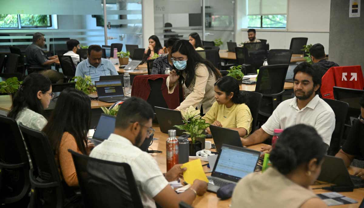 Go Digit Insurance employees working at their office in Bengaluru. Adarsh Agarwal, appointed actuary at Go Digit. — AFP