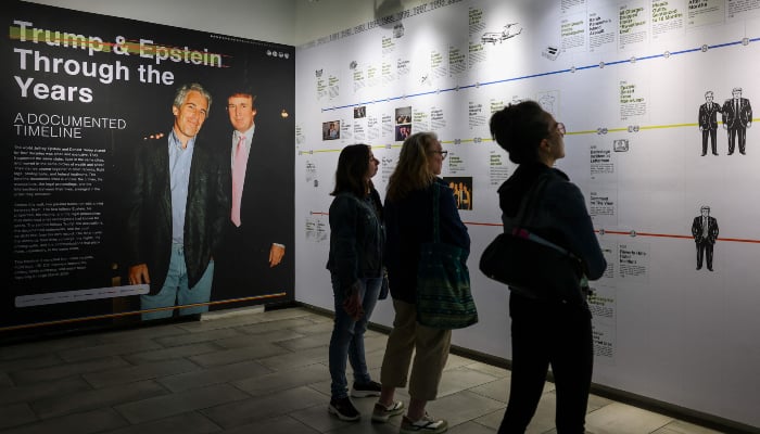 Visitors look at a timeline of events at the Donald J Trump and Jeffrey Epstein Memorial Reading Room, a tribute to the survivors and victims of Epsteins crimes, where 3.5 million pages, 3,437 bound volumes of the Epstein files are displayed in New York City on May 11, 2026. — AFP