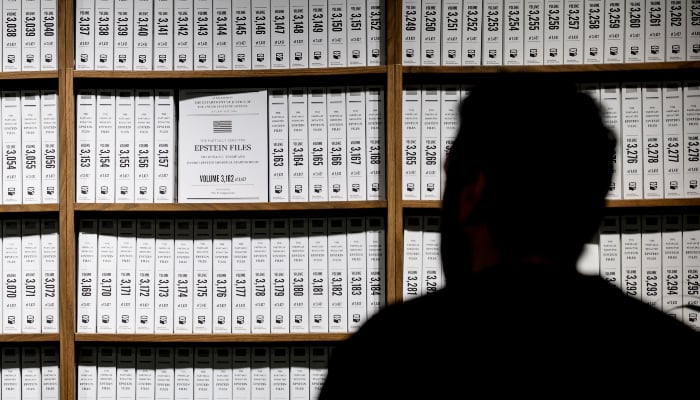 Visitors look at a timeline of events at the Donald J Trump and Jeffrey Epstein Memorial Reading Room, a tribute to the survivors and victims of Epsteins crimes, where 3.5 million pages, 3,437 bound volumes of the Epstein files are displayed in New York City on May 11, 2026. — AFP