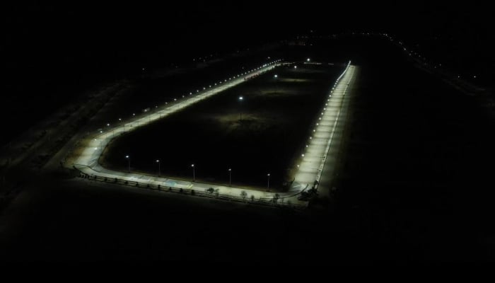 An aerial view shows a floodlit racetrack prepared for night motorsports events in Karachi. — Reporter