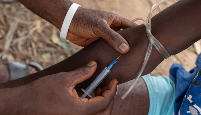 A drug addict uses a syringe in Abuja on February 24, 2026. — AFP