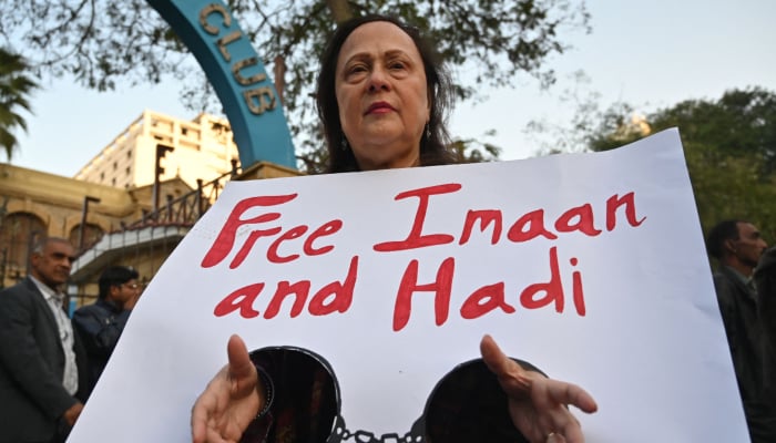 A woman holds a placard during a protest against the arrest of human rights lawyer Imaan Mazari and her husband, fellow lawyer Hadi Ali Chattha, in Karachi on January 26, 2026. — AFP