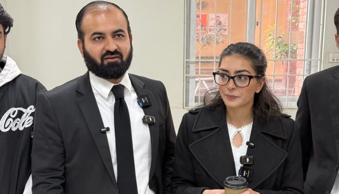 Human rights lawyer Imaan Mazari (right) with her husband and fellow lawyer Hadi Ali Chattha (left), during a court hearing in Islamabad, on December 5, 2025. — AFP