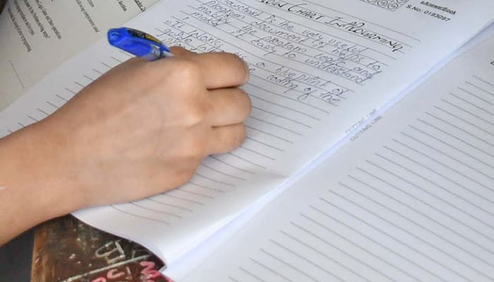 (Representational) A student attempts their question paper in Karachi, on April 10, 2026. — Online