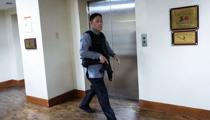A member of the Senate security walks, after gunshots were heard at the Philippine Senate, as chaos mounted in anticipation of an attempt to arrest a top senator wanted by the International Criminal Court, in Pasay City, Metro Manila, Philippines, May 13, 2026. — Reuters