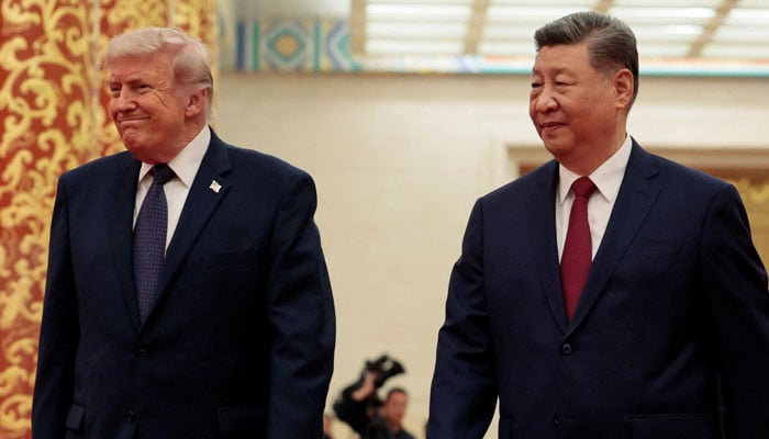 US President Donald Trump (left) and Chinese President Xi Jinping arrive to attend a state banquet at the Great Hall of the People in Beijing, China, May 14, 2026. — Reuters