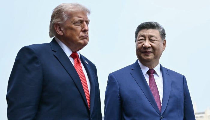 Chinas President Xi Jinping (R) and US President Donald Trump visit the Temple of Heaven in Beijing on May 14, 2026. — AFP