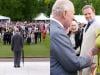 King Charles leads rain-soaked garden party solo as royals busy elsewhere