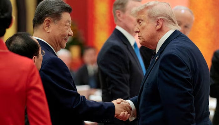 Chinese President Xi Jinping and U.S. President Donald Trump shake hands at a state banquet at the Great Hall of the People in Beijing, China, May 14, 2026. — Reuters