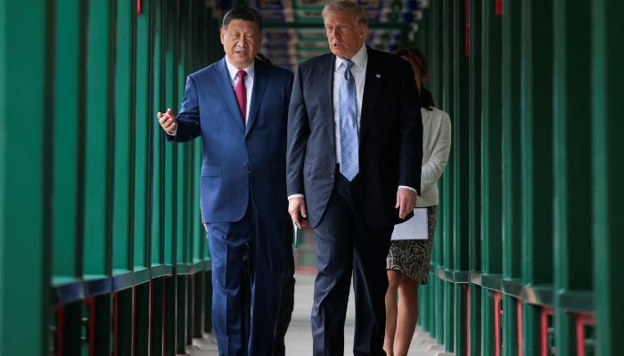 US President Donald Trump participates in a friendship walk through Zhongnanhai Garden with Chinese President Xi Jinping in Beijing, China, May 15, 2026. — Reuters