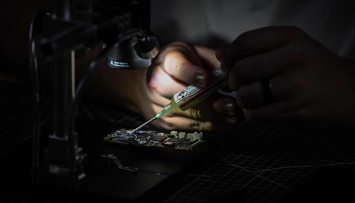 A staff member works on a drones printed circuit board in the drone manufacturing room, at the headquarters of the startup Campus Guardian Angel, on May 8, 2026, in Austin, Texas. — AFP
