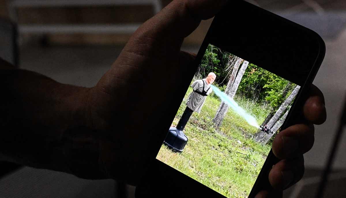 Khristof Oborski, director of tactical operations at Campus Guardian Angel, shows a picture on his cell phone of a drone firing tear gas at a mannequin during, a demonstration on how to neutralize a shooter at a school, at the headquarters of the startup Campus Guardian Angel on May 8, 2026, in Austin, Texas.— AFP