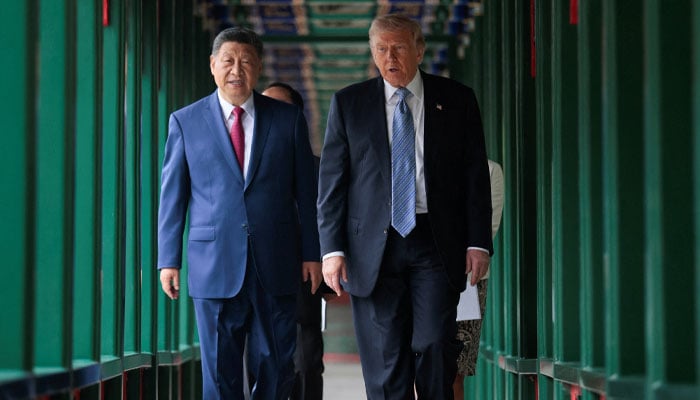 US President Donald Trump participates in a friendship walk through Zhongnanhai Garden with Chinese President Xi Jinping in Beijing, China, May 15, 2026. — Reuters