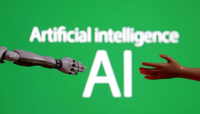 Words reading Artificial intelligence AI, miniature of robot and toy hand are pictured in this illustration taken December 14, 2023. — Reuters
