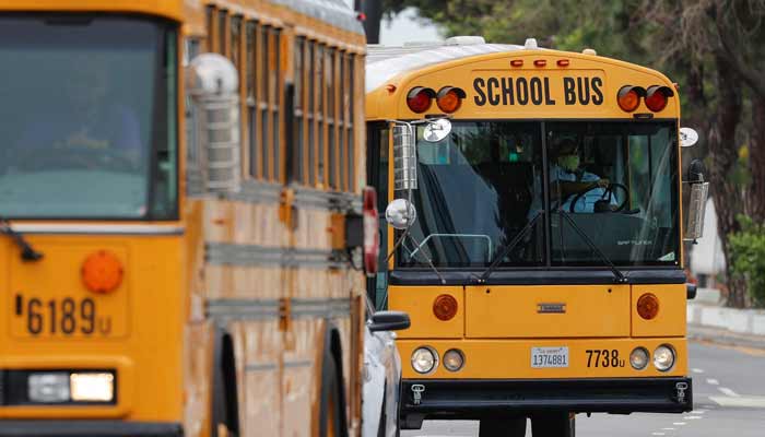 School bus drivers lead a caravan through downtown Los Angeles to demand that Congress and California legislators provide sufficient funding to ensure all students have the support they need for distance learning. — Reuters/File