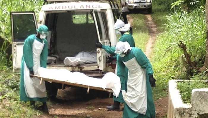 Health workers carry the body of an Ebola virus victim in Kenema, Sierra Leone June 25, 2014.— Reuters