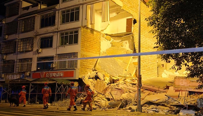 Rescue workers walk past a damaged building following an earthquake at Taiyang village in Liuzhou, Guangxi Zhuang Autonomous Region, China May 18, 2026. — Reuters