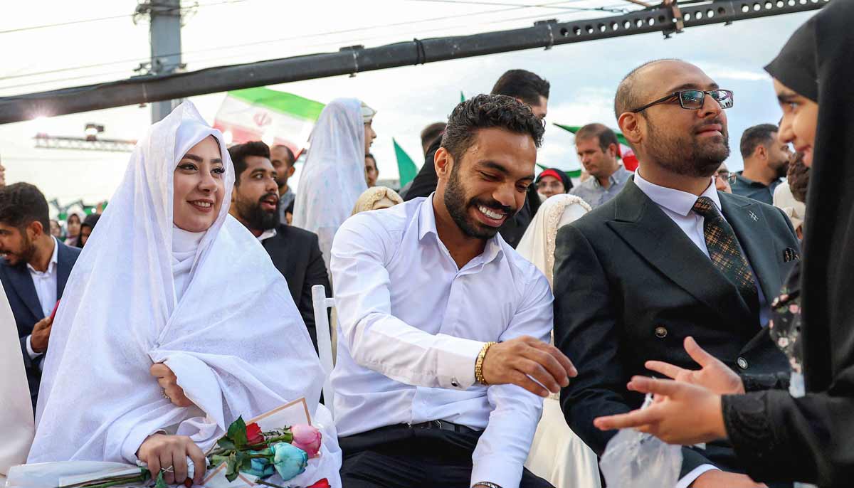 Bride and groom couples attend a public mass wedding ceremony at Imam Hossein Square in Tehran on May 18, 2026.— AFP