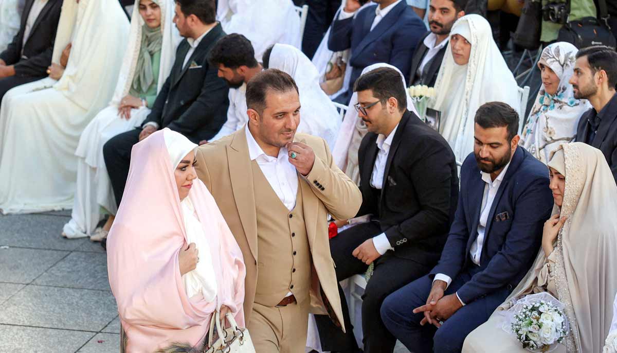 Bride and groom couples attend a public mass wedding ceremony at Imam Hossein Square in Tehran on May 18, 2026.— AFP