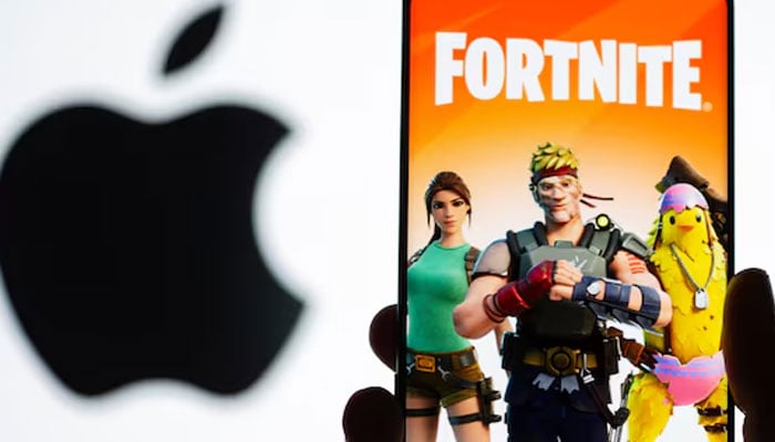 Fortnite game graphic is displayed on a smartphone in front of Apple logo in this illustration taken May 2, 2021.— Reuters