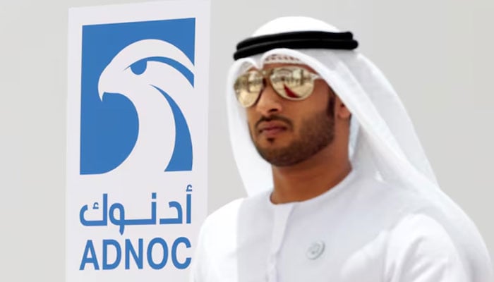 An Emirati man is seen near the logo of ADNOC in Ruwais, United Arab Emirates May 14, 2018. — Reuters