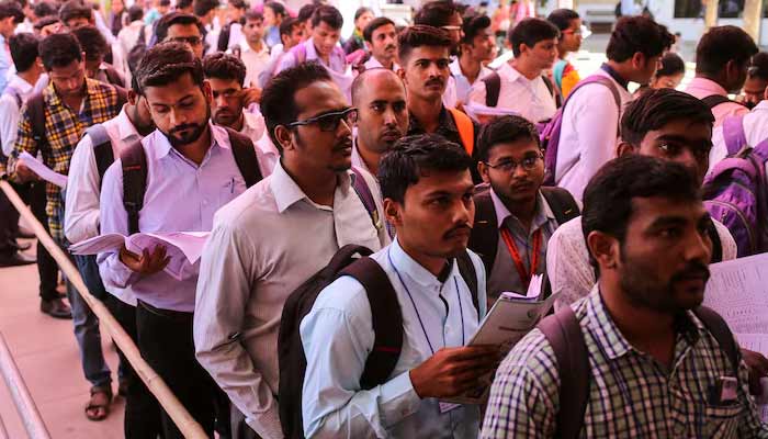 Job seekers line up for interviews at a job fair in Chinchwad, India, February 7, 2019.— Reuters