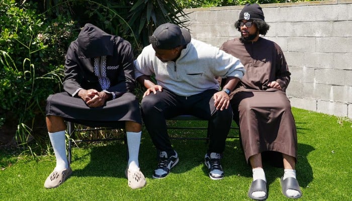 Jibril Abdullah, Mohammed Abdullah and Khalid Abdullah, sons of security guard Amin Abdullah, who was killed in a shooting incident, sit outside their home in San Diego, California, US, May 20, 2026. — Reuters