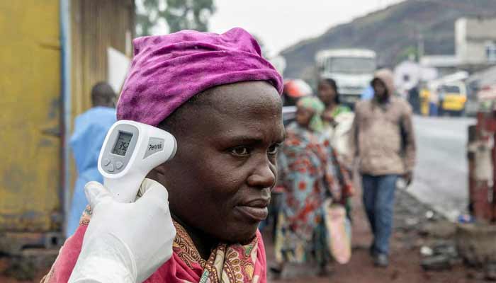 A health worker takes the temperature of a woman passing through the Kanyaruchinya checkpoint, as authorities and aid agencies intensify efforts to contain a new Ebola outbreak involving the Bundibugyo strain, in the northern entry into the city of Goma, North Kivu province, the Democratic Republic of the Congo May 20, 2026.— Reuters/File
