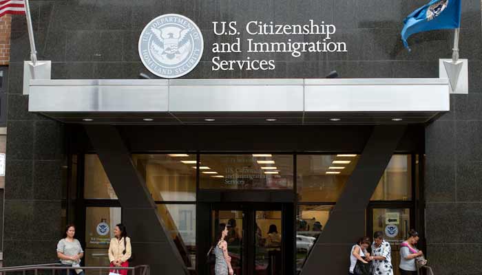 People stand on the steps of the US Citizenship and Immigration Services offices in New York. — Reuters/File
