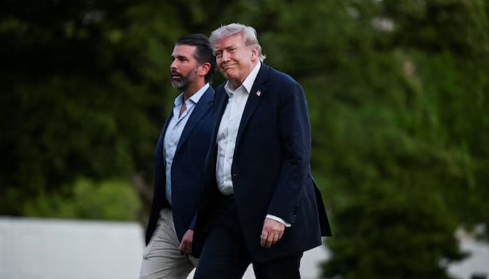 US President Donald Trump and his son Donald Trump Jr. arrive at the White House in Washington, DC, US, May 3, 2026. — Reuters