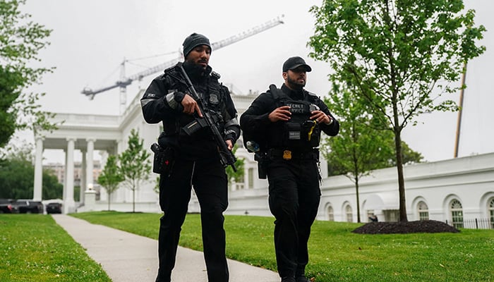 US Secret Service agents walk at the White House after alleged gunshots were heard nearby, at the White House in Washington, DC, US, May 23, 2026. — Reuters