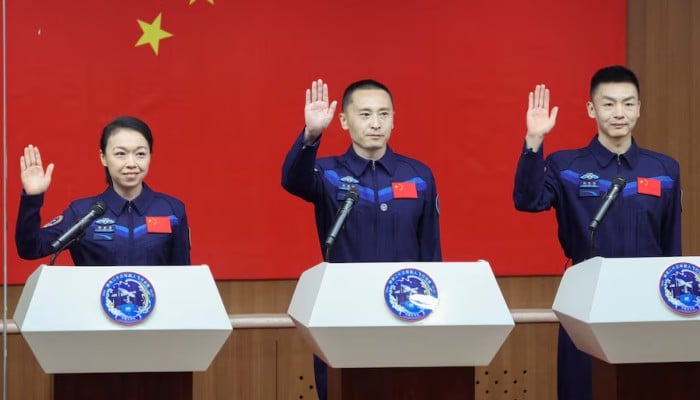 Astronauts Zhu Yangzhu, Zhang Zhiyuan, and Lai Ka-ying, who is the first astronaut from Hong Kong, gesture as they attend a press conference before the Shenzhou-23 spaceflight mission to Chinas Tiangong space station, at Jiuquan Satellite Launch Centre, near Jiuquan, Gansu province, China, May 23, 2026. — Reuters