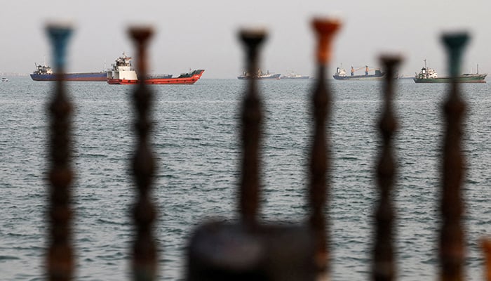 Vessels in the Strait of Hormuz are visible near the beach of Bandar Abbas, Iran, May 22, 2026. — Reuters