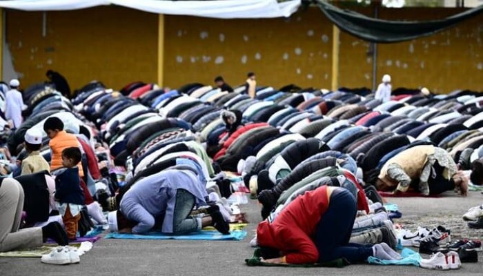Muslims gather on the private parking lot of a construction site for the half-day prayer in Monfalcone, on April 26, 2024. — AFP