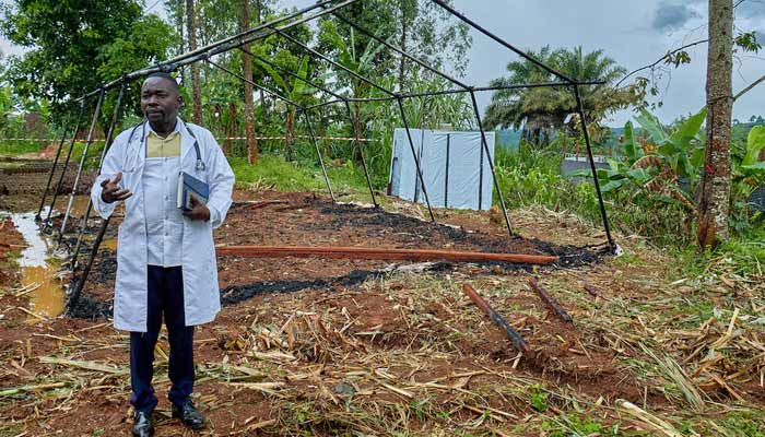 Medical Director of Mungwalu General Hospital Richard Lokudu speaks to Reuters next to the burned remains of a destroyed Médecins Sans Frontières (MSF) emergency isolation tent. — Reuters