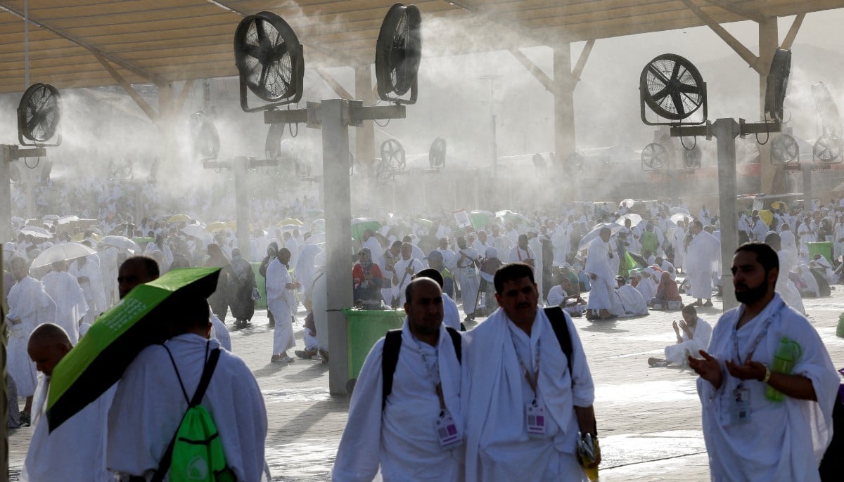Muslim pilgrims gather near misting fans at Mount of Mercy on the plain of Arafat during the annual Hajj pilgrimage, outside the holy city of Mecca, Saudi Arabia, May 26, 2026. — Reuters