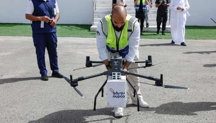 A member of the medical staff demonstrates how to transport medical supplies by drone across the Arafat area near Islams holy city of Makkah ahead of the annual Hajj pilgrimage, on May 23, 2026. — AFP