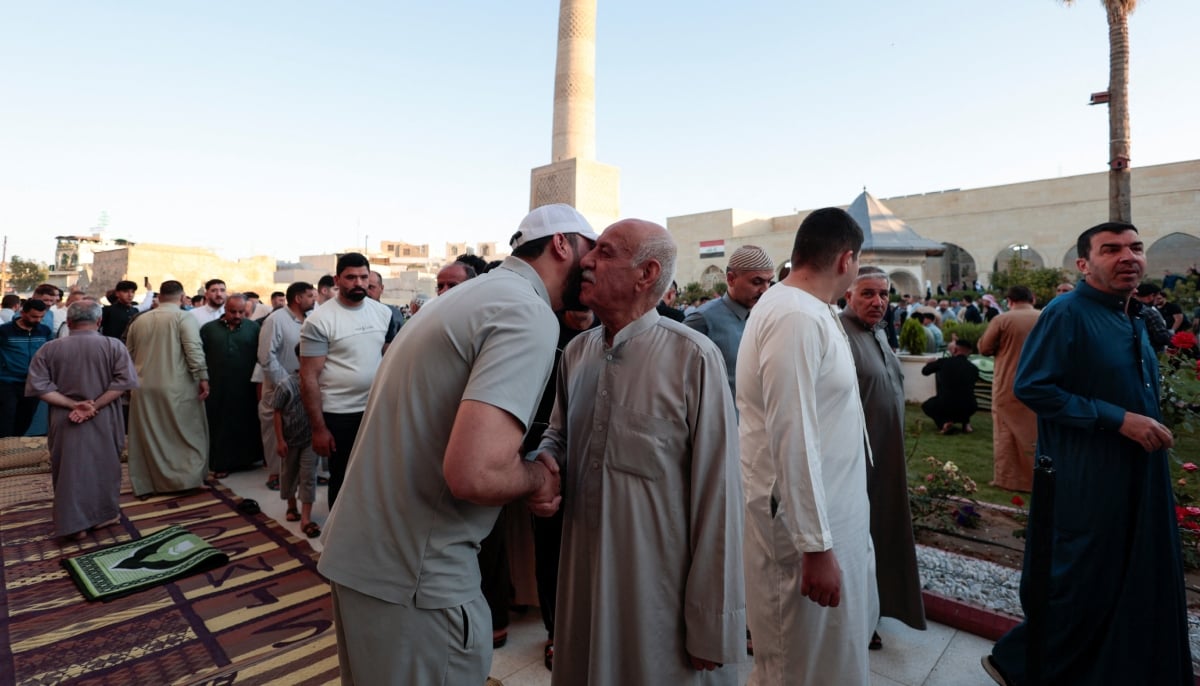 Muslims exchange greetings after Eid ul Adha prayer, in Mosul, Iraq, May 27, 2026. — Reuters