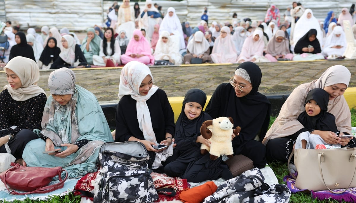 A girl holds a doll as she attends to offer Eid ul Adha mass prayers at the Great Mosque of Al Azhar in Jakarta, Indonesia, May 27, 2026. — Reuters