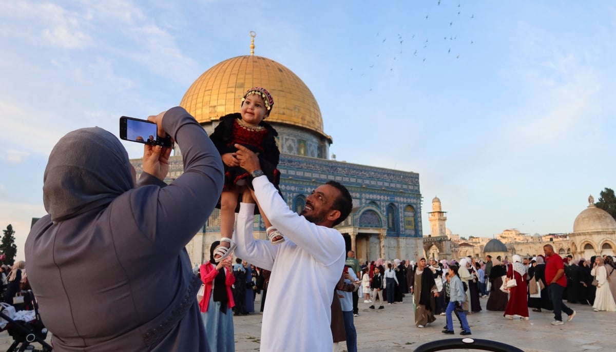 Palestinian families celebrate Eid ul Adha at the Al-Aqsa mosque, in Jerusalem, May 27, 2026. — Reuters