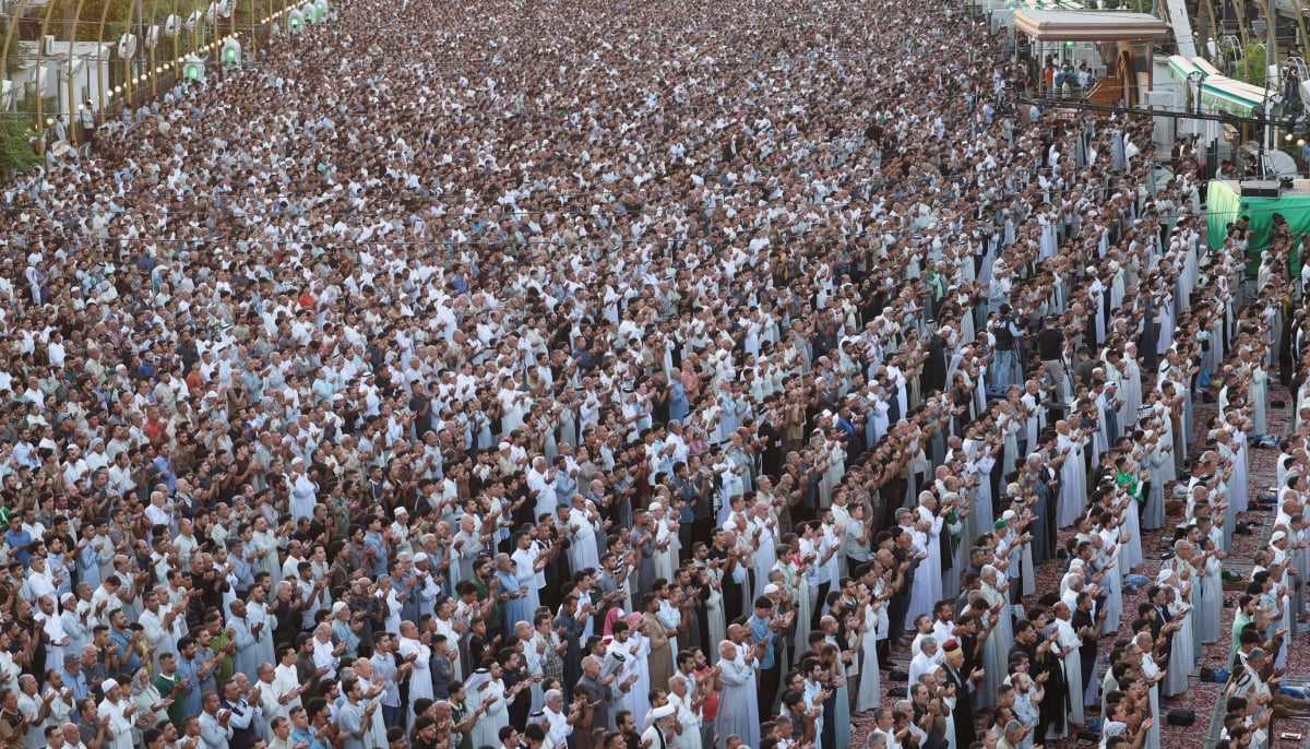 Muslim worshippers perform Eid ul Adha prayers between the shrines of Imam Hussein and Imam Abbas in the holy city of Karbala, Iraq, May 27, 2026. — Reuters