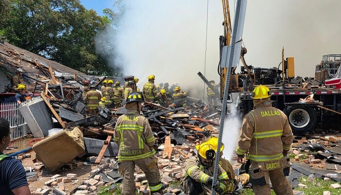 Firefighters engaged in rescue operation at the site of gas explosion in Dallas. — Reporter