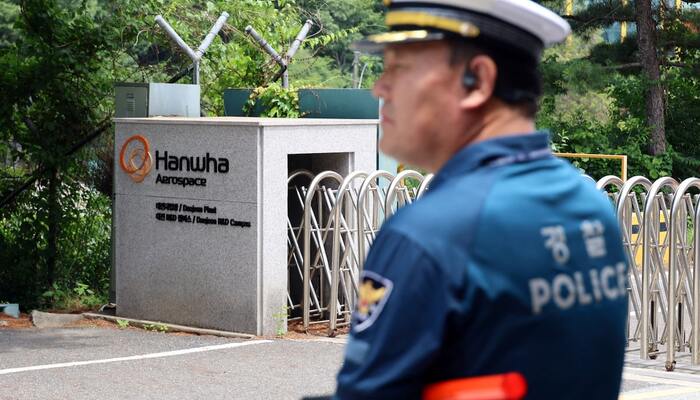 A police officer controls the area in front of the main gate of Hanwha Aerospace’s factory that caught fire after an explosion, in Daejeon, South Korea, June 1, 2026. — Reuters