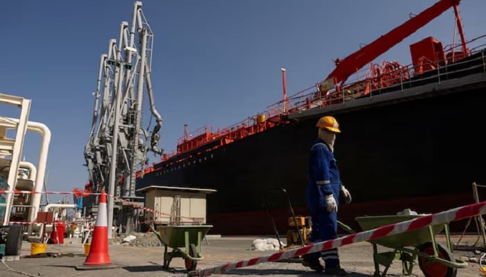 A person works near an oil tanker docked at the Port of Fujairah, as the US-Israel conflict with Iran limits marine traffic in the Strait of Hormuz, in Fujairah, United Arab Emirates, May 6, 2026.— Reuters