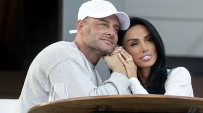 Katie Price refuses to give up on marriage as she flies to meet jailed husband