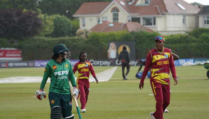Pakistans Tuba Hassan (left) and West Indies players walk off the field after rain interruption during their Ireland-hosted T20I tri-series match at the Castle Avenue in Dublin on June 3, 2026. — X/@TheRealPCB