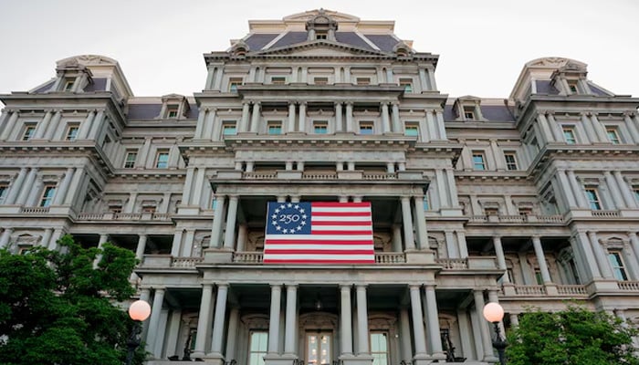 An America250 flag decorates the Eisenhower Executive Office Building, which US President Donald Trumps administration has proposed to paint white, in Washington, DC, US, May 7, 2026. — Reuters