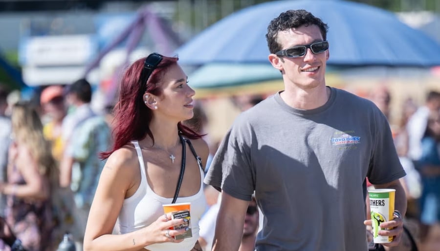 Dua looked incredibly toned in a black sports bra and matching leggings as she linked arms with her new husband