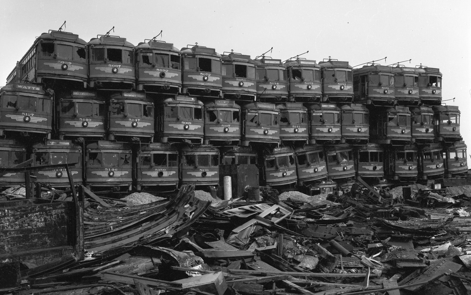 Old Pacific Electric cars are piled up at a junkyard in Terminal Island. — Commons.wikimedia.org